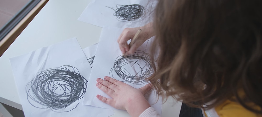 Child scribbling chaotic drawing