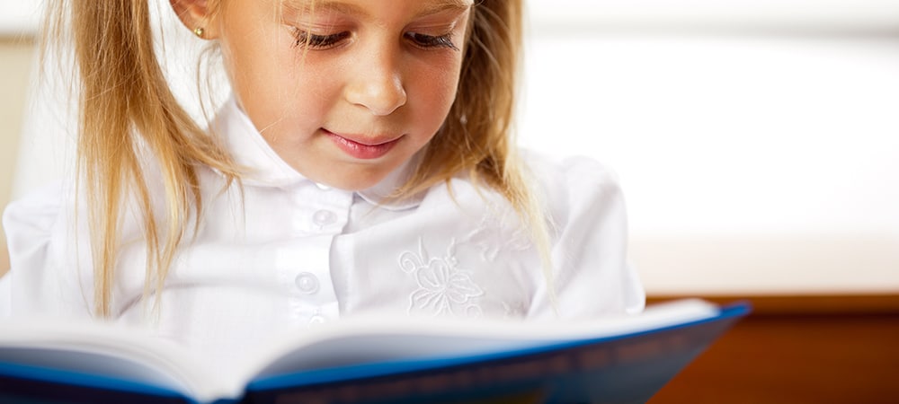 Young pupil reading book