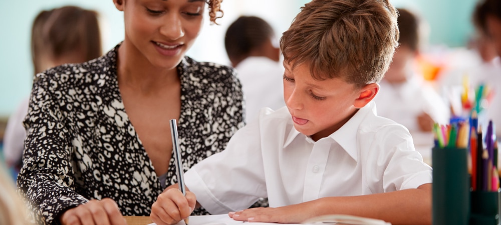 Female teacher helping pupil