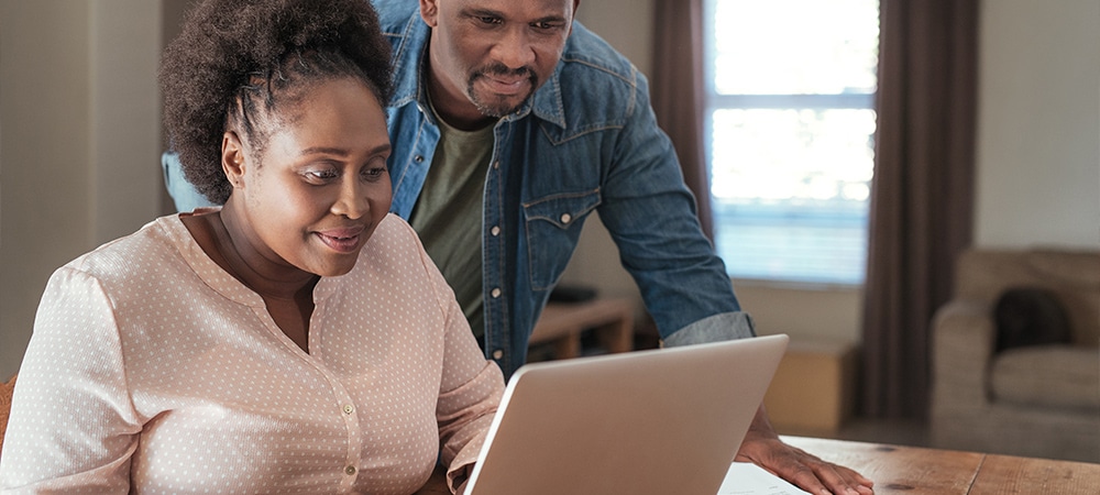 Parents looking at school website on laptop