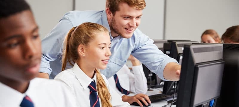 teacher-helping-secondary-pupil-on-computer-800x360