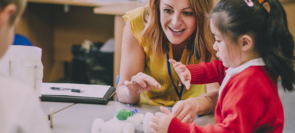 Early career teacher helping pupil